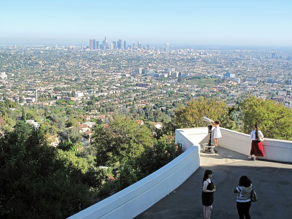 Griffith Observatory at dusk with city lights below in Los Angeles
