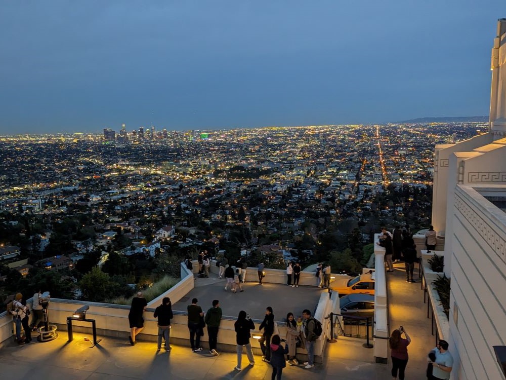 Griffith Observatory at dusk with city lights below in Los Angeles