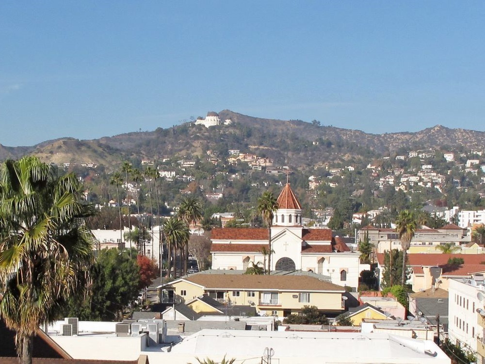View of Griffith Park from Sunset Boulevard showing the Hollywood Sign and Griffith Observatory
