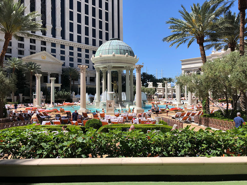 Outdoor pool area at Caesars Palace with Roman-style columns and landscaping, Las Vegas