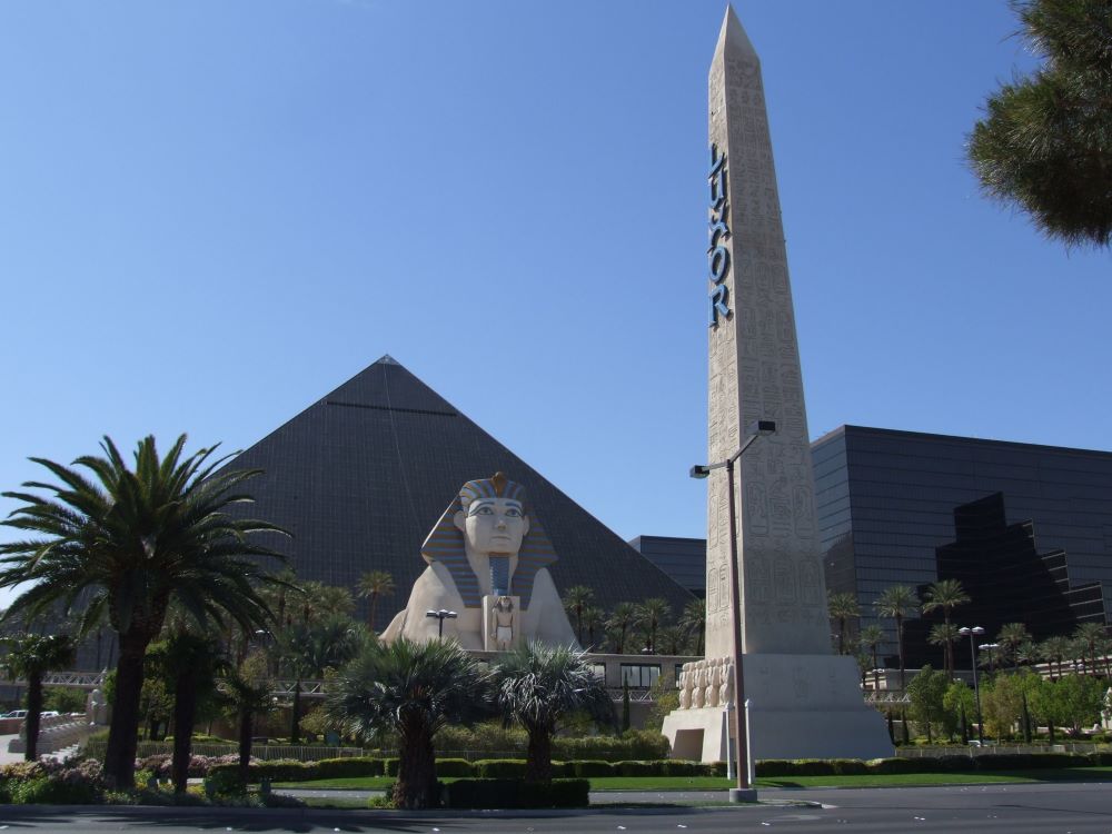 Wide panoramic view of Luxor Hotel and Casino pyramid at night in Las Vegas