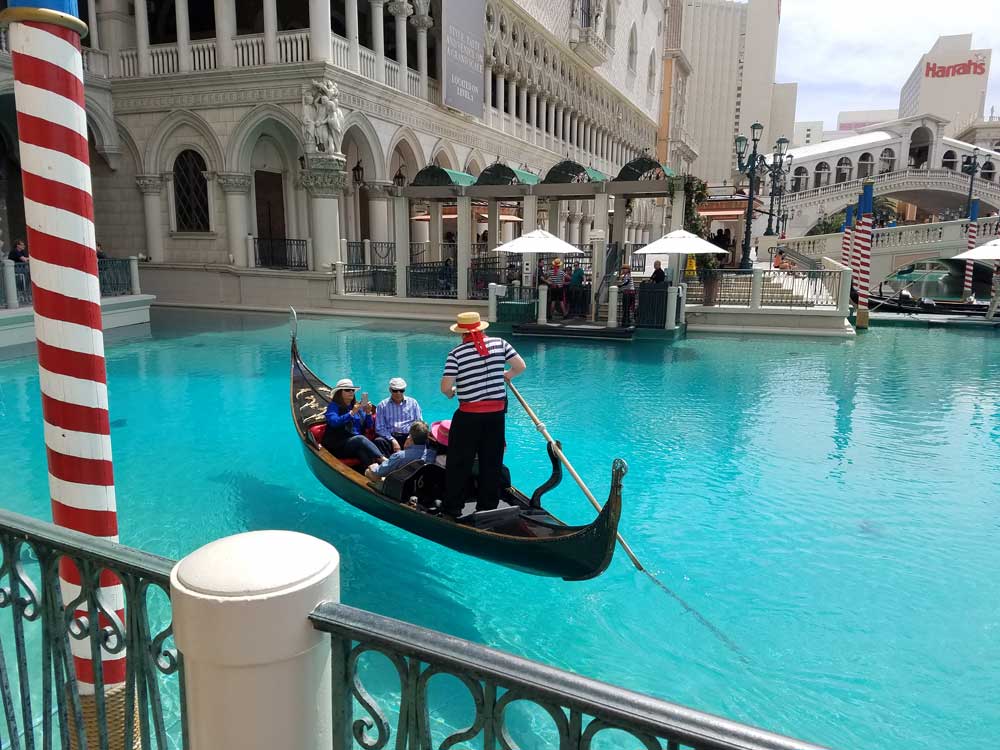 Gondolier guiding a gondola through the indoor Grand Canal at the Venetian Las Vegas
