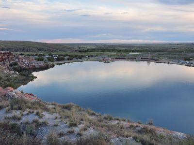 Turquoise spring-fed sinkhole lakes surrounded by red desert bluffs at Bottomless Lakes State Park, New Mexico