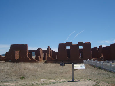 Ruins of Fort Union National Monument, adobe chimney stacks rising from crumbled walls in New Mexico grassland
