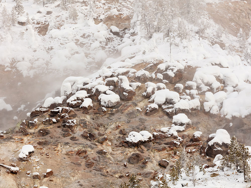 Snow and steam rising from Roaring Mountain, Yellowstone National Park