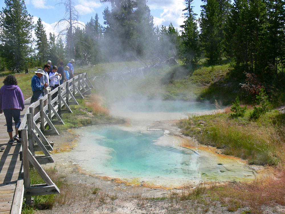 Visitors on the boardwalk at West Thumb Geyser Basin